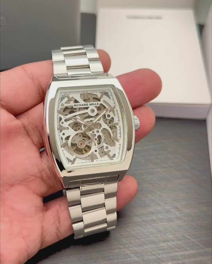 Richard Mille RM 010 Automatic model or a variation thereof. The RM 010 is known for its skeletonized design, tonneau-shaped case, and automatic winding movement.